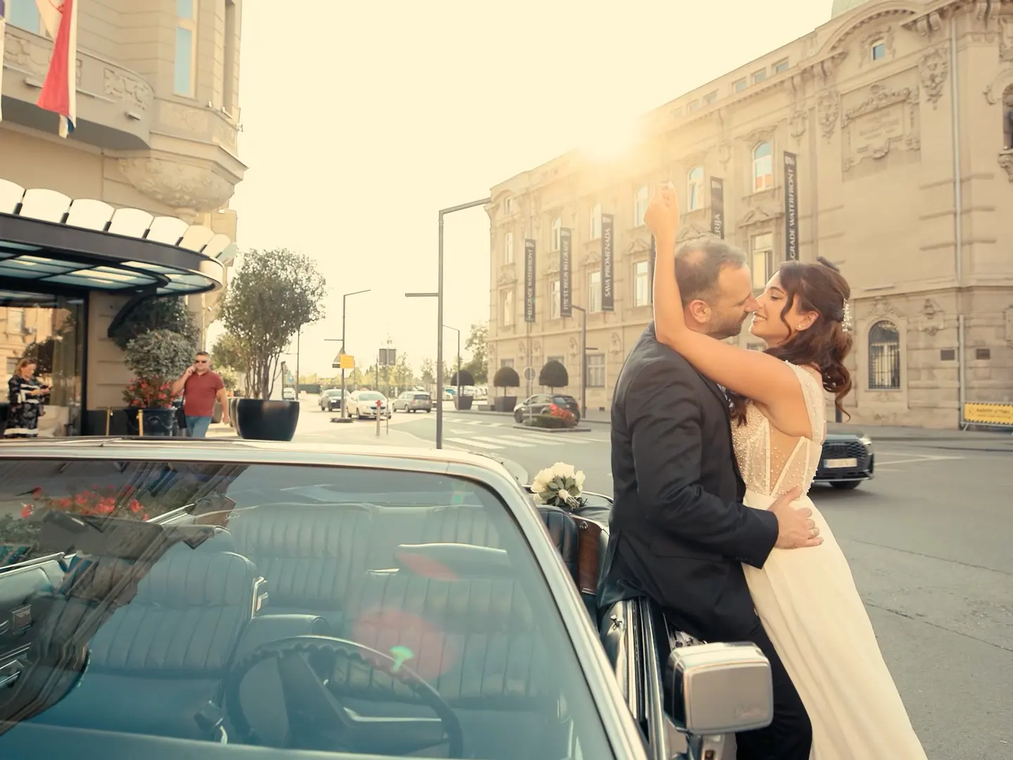 A couple embracing beside a car in Belgrade
